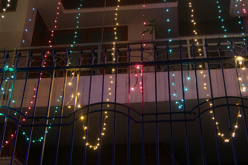 Stock photo of house decorated with multicolour fairy lights for Indian traditional festival of lights, Diwali like Christmas.\n\n\nClose-up image of house decorated with multicolour fairy lights for Indian traditional festival of lights, Diwali like Christmas.