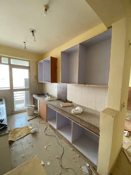 istock Image of new kitchen being fitted, kitchen fitters, cabinets / cupboards, tools and sawdust 1301654465