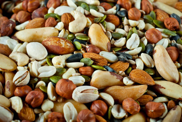 istock Many types of nuts close up. Textures of different nuts. Nuts are dumped in a pile. 1301655589