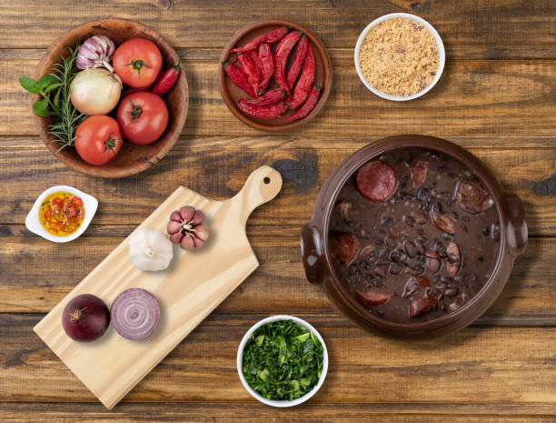 istock Traditional brazilian feijoada with ingredients, kale and manioc flour 1301658423