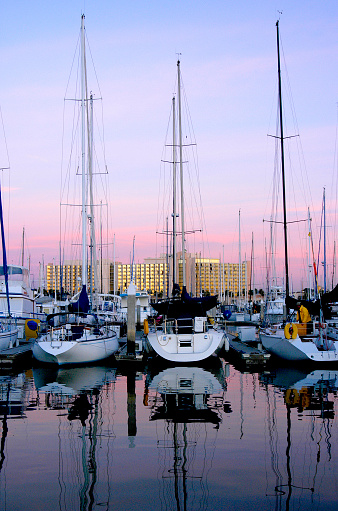 San Diego marina with sail boats in their docks and put away until another day of pleasure sailing.