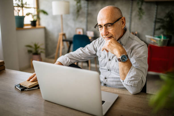 istock Senior man working in his home office 1301667369