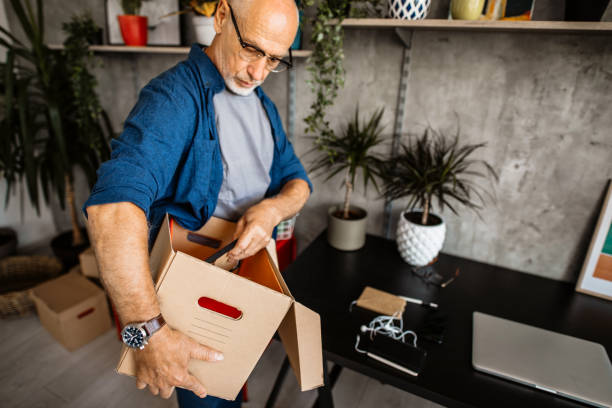 istock Senior man organizing and cleaning home office 1301668072
