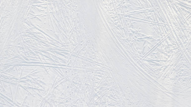 istock Snow-covered ice with ski tracks large top aerial view 1301668135