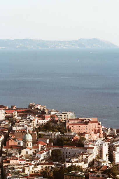 Napoli with view over the gulf of Naples View over old town Naples from the Castel Sant’Elmo with the coastline of the Amalfi and Sorrento in the background amalfi coast map stock pictures, royalty-free photos & images