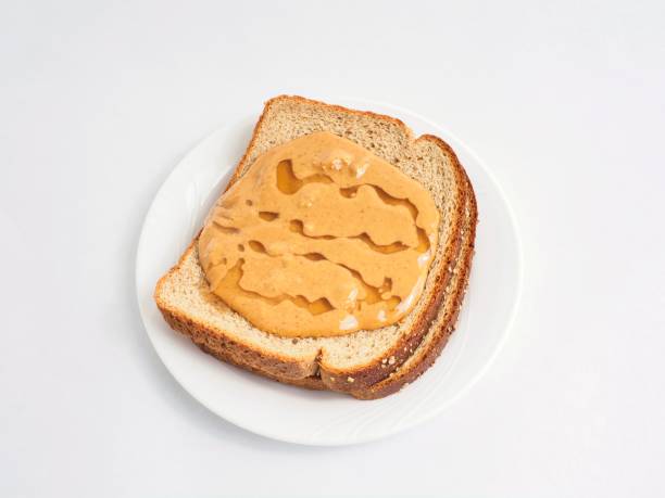 Natural peanut butter on whole grain bread with honey