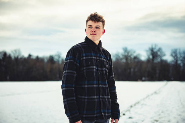 istock Young man walking outdoors in snow covered winter landscape 1301676396