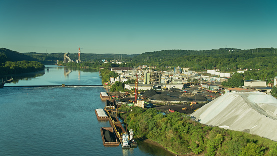Aerial shot of the small town of Elizabeth, Pennsylvania on a summer morning. The shot includes coal barges on the Monongahela River.