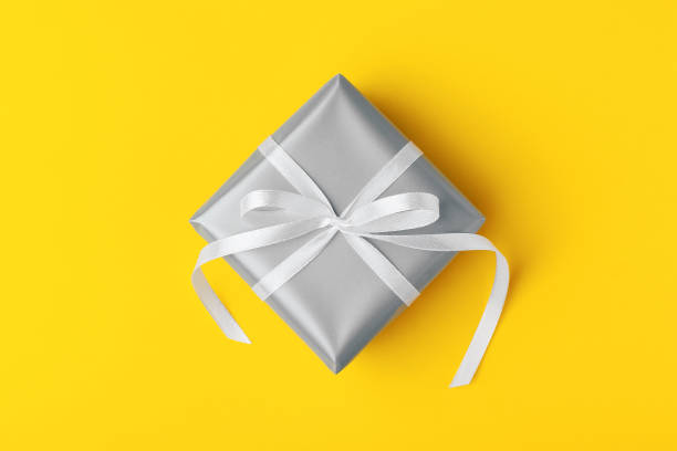 istock Attractive gift on the yellow background. 1301677588