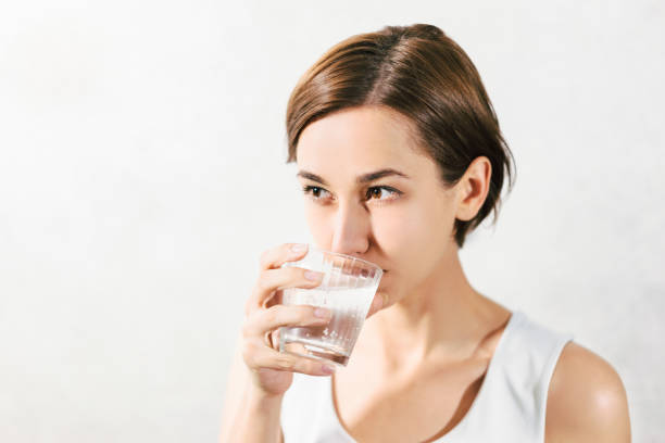 istock Young woman holding water 1301679068
