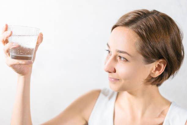 istock Young woman holding water 1301679151