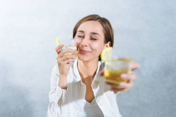 istock woman holding a highball (whiskey) 1301679155