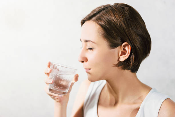 istock Young woman holding water 1301679171