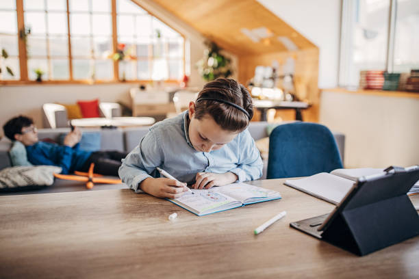 istock Boy attending online school class from home 1301679330