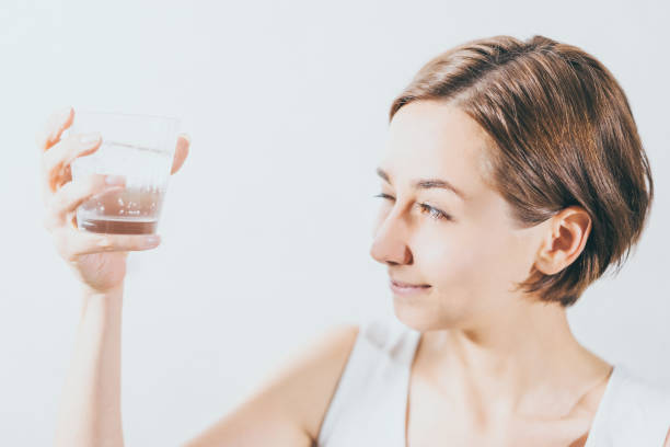 istock Young woman holding water 1301679343