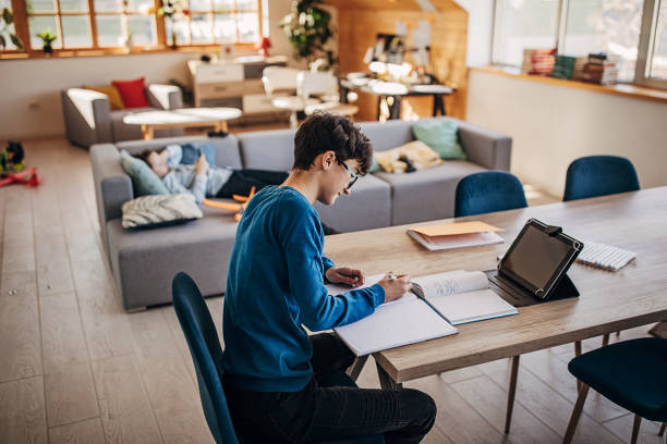 istock Boy attending online school class from home 1301679361