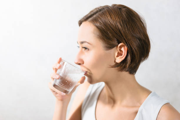 istock Young woman holding water 1301679930