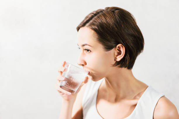 istock Young woman holding water 1301679943