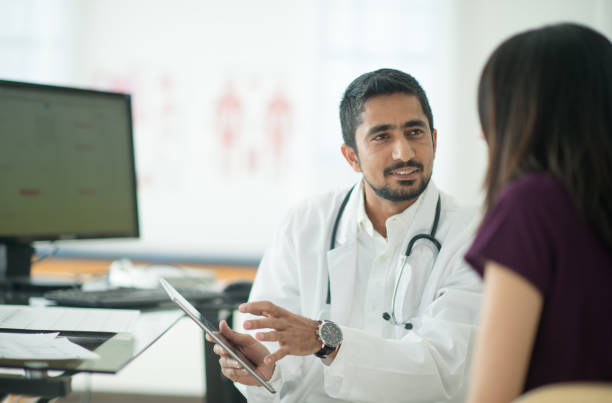 istock Doctor showing his patient information on a tablet 1301683543