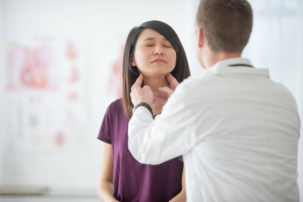 istock Doctor examines patient's throat 1301683547