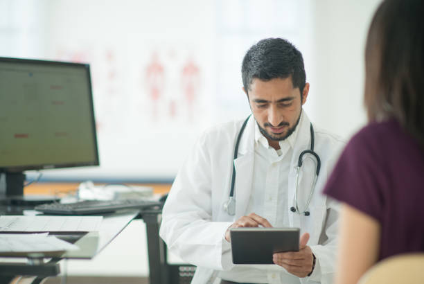 istock Doctor meeting with patient at his office 1301683549