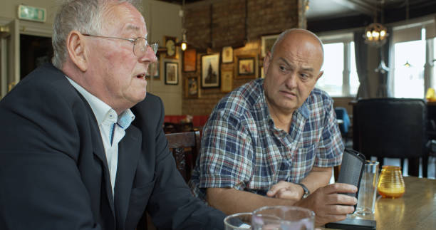 istock Man Listening to Friend Talking with Dubious Look on His Face 1301686580
