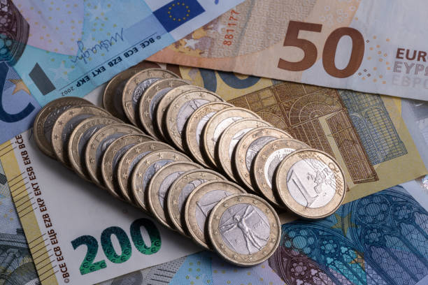 1 euro coins lie on the background of European denominations of various denominations 1 euro coins lie on the background of European denominations of various denominations european union photos stock pictures, royalty-free photos & images