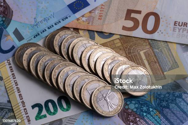 1 Euro Coins Lie On The Background Of European Denominations Of Various Denominations Stock Photo - Download Image Now