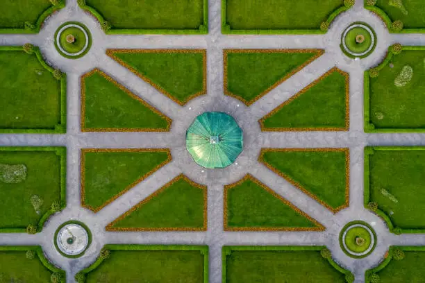 Photo of Symmetrial aerial view at a green park with a temple in its center, straight top down from above, popular architecture photo.