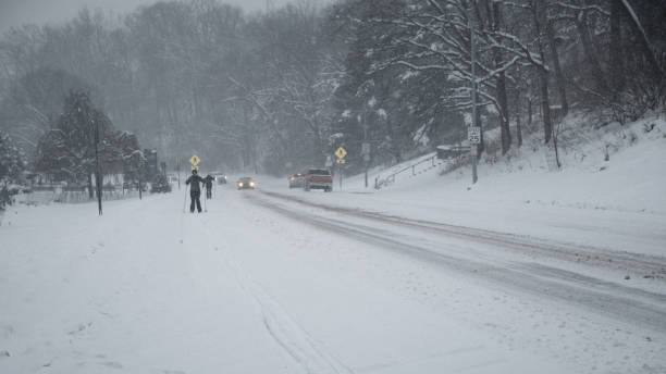 istock People Skiing on the Street During a Snowstorm 1301689528
