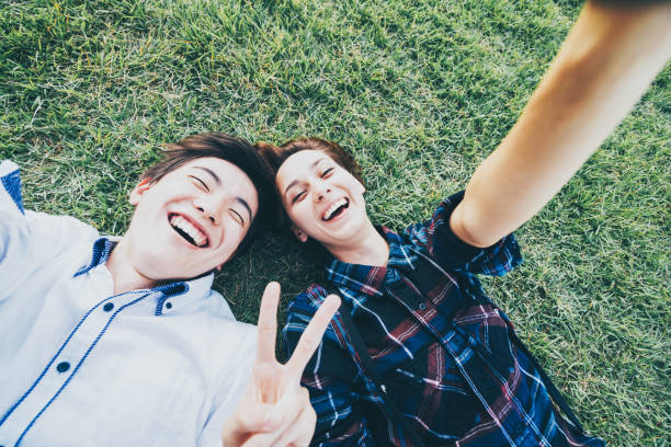 Men and women taking selfies against a green background (selfie / shooting)