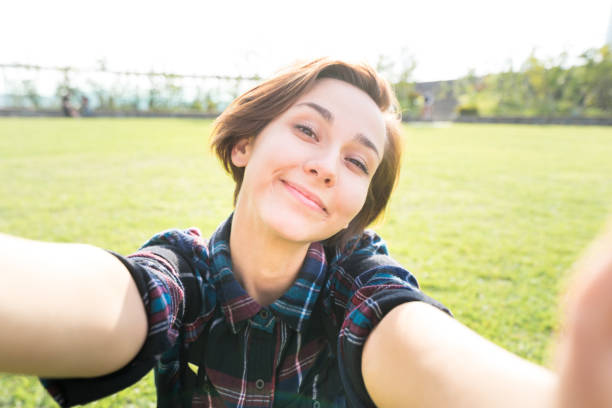 istock Young smiling woman looking at the camera (selfie / shooting) 1301694304