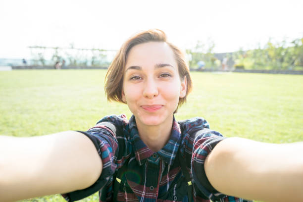istock Young smiling woman looking at the camera (selfie / shooting) 1301694506