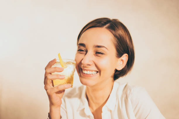 istock woman holding a highball (whiskey) 1301695049