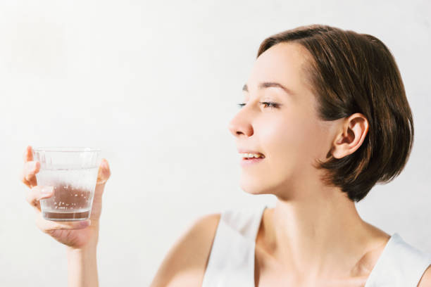 istock Young woman holding water 1301695056