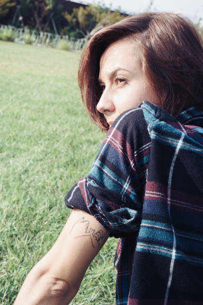 istock Woman with tattoo on her arm 1301695213