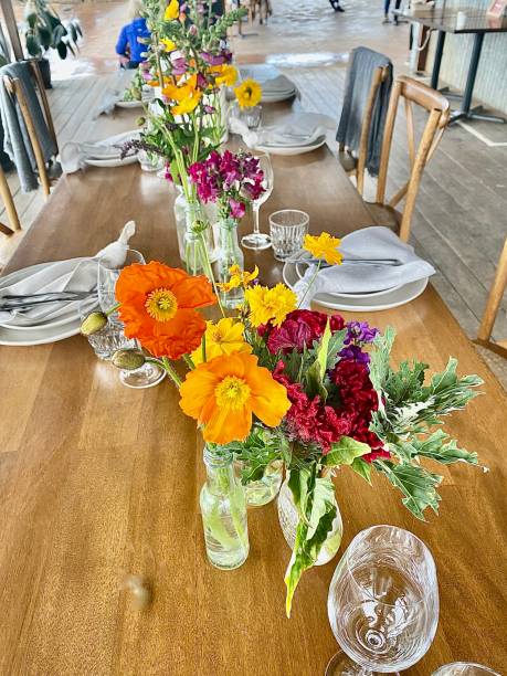 istock CPretty Flower arrangement on Wodden Restaurant Dining Table 1301697934