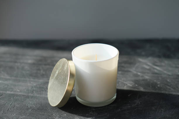istock organic soy wax candle in a glass on a grey table. 1301700784