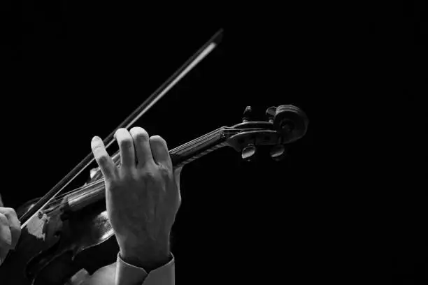Photo of Violinist hands on black background