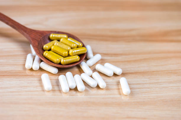 istock Herbal supplement in wooden spoon 1301703237