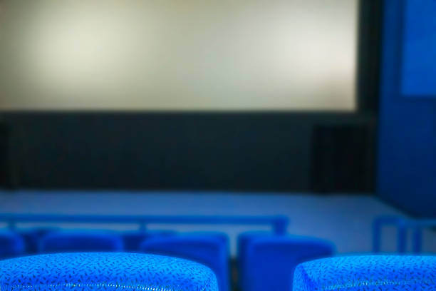 istock Cinema hall with empty screen and Blue seats (armchairs 1301703364