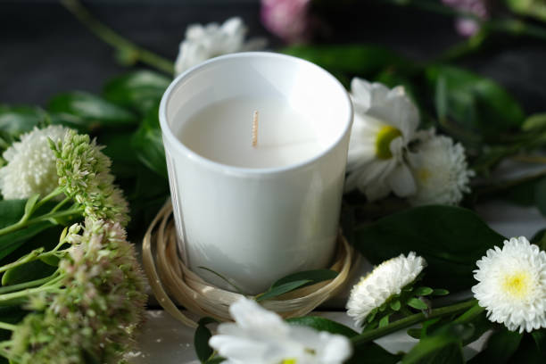 istock white scented candle and delicate flowers 1301704616