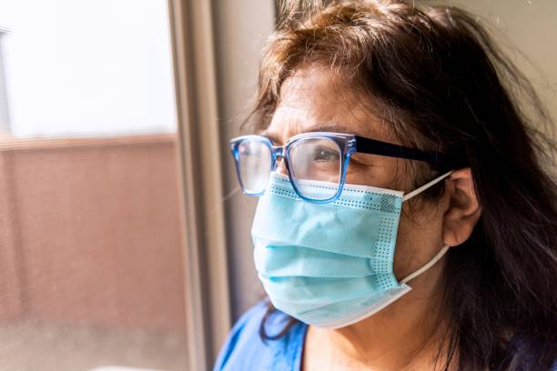 istock Mature senior hispanic woman wearing a protective face mask 1301705256