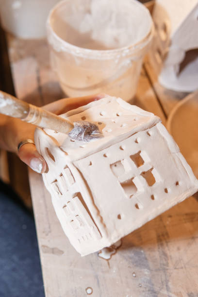 istock A master ceramist holds a clay product in his hands. Making a ceramic candle holder from clay. The process of coating the candlestick with glaze 1301706964