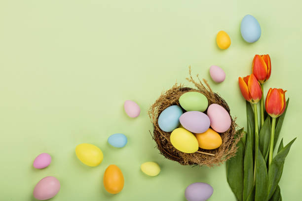 istock Stylish background with colorful easter eggs pastel colors isolated on green background. Flat lay, top view, mockup, overhead, template 1301707617