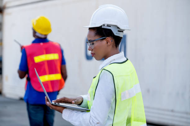 istock American African technician worker woman touch and look to laptop while her co-worker use walkie-talkie to communicate other 1301707773