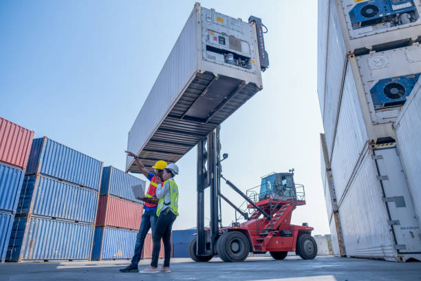 istock Wide shot of couple foreman and technician or cargo container worker or engineer help to work together 1301707791