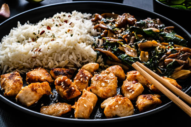 istock Fried chicken nuggets with fried potatoes and fresh vegetables  on gray table 1301707844