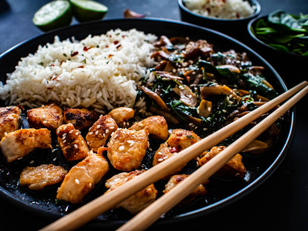 istock Fried chicken nuggets with fried potatoes and fresh vegetables  on gray table 1301708397