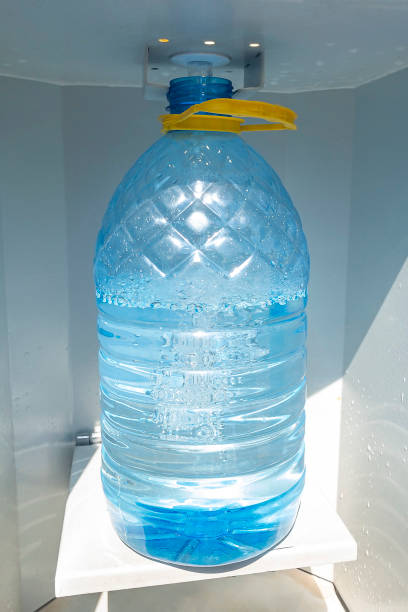 istock Water machine. Water is poured in plastic bottle. 1301710572
